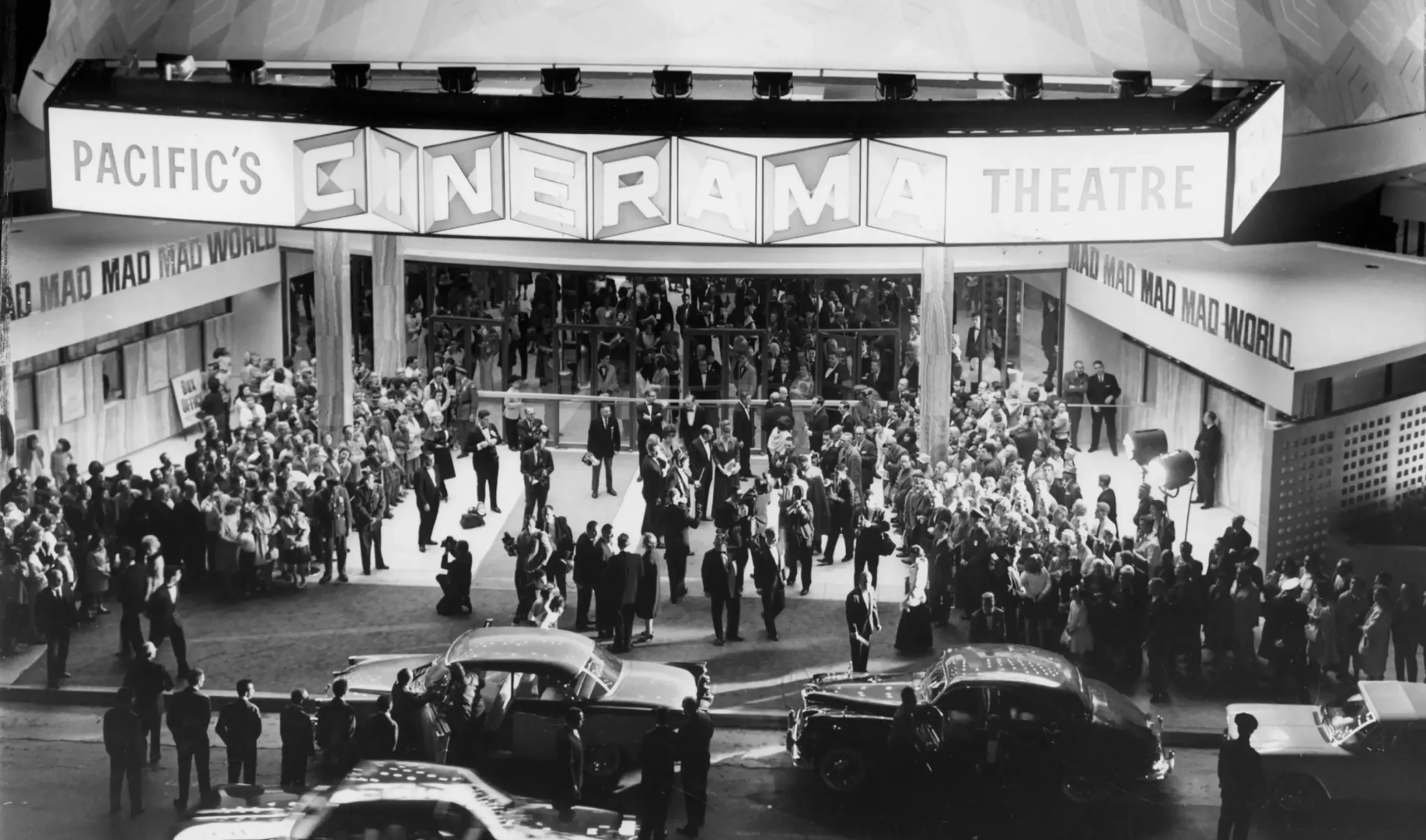 Black and white historical photo of a movie premier at Cinerama in Los Angeles, CA